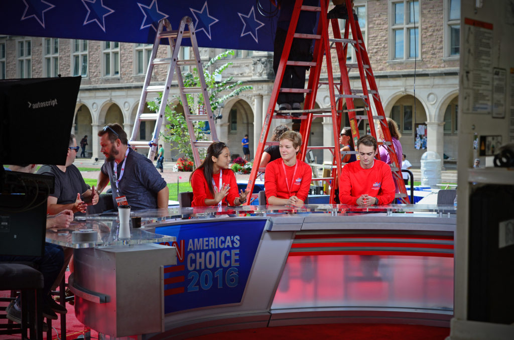 Students have many great opportunities to volunteer. Here, they test the CNN set on Beaumont Pavilion in Brookings Quadrangle. (Photo: James Byard/Washington University)